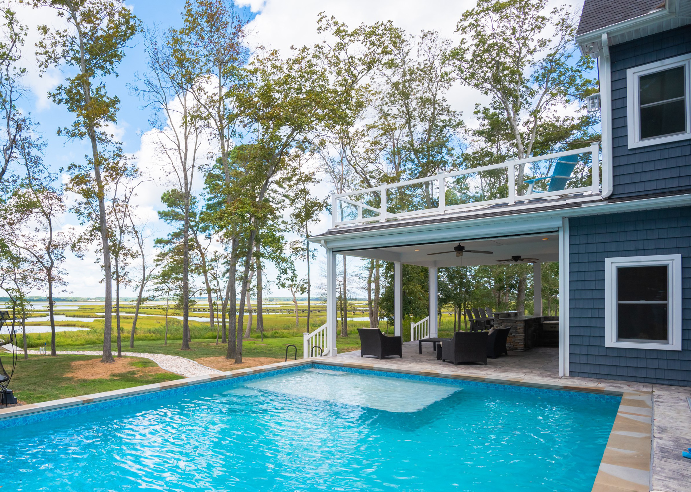 a house with a patio and outdoor pool.