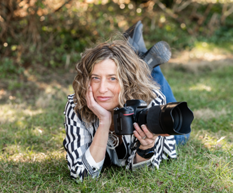 A headshot of Dona Jung with her camera.